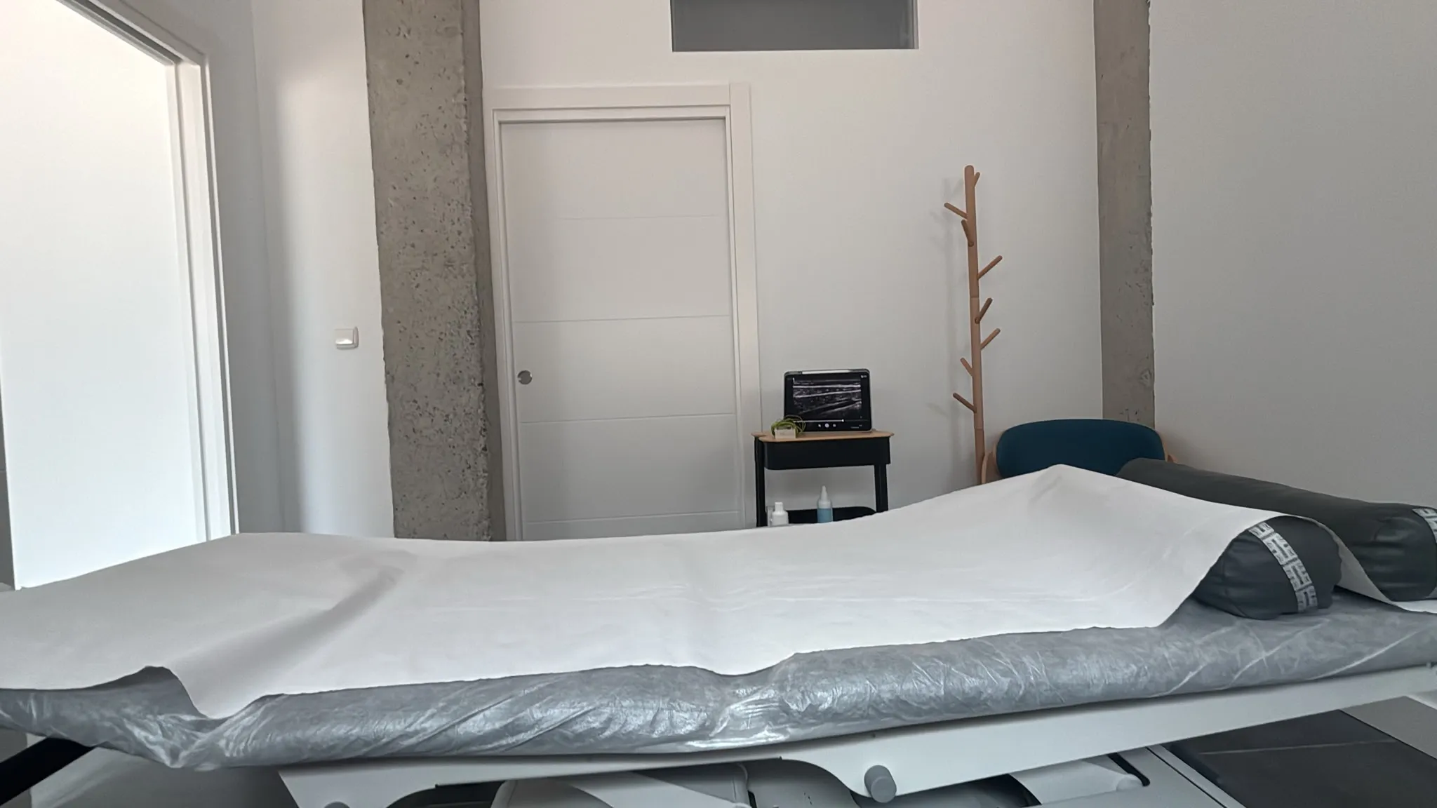 Sala de tratamiento de Laguntza Fisioterapia con camilla y ecógrafo, Urnieta